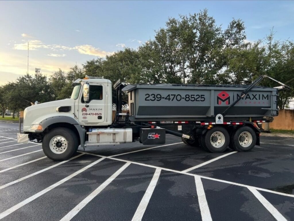 Maxim Disposal Mack roll-off truck with USDOT number on the door